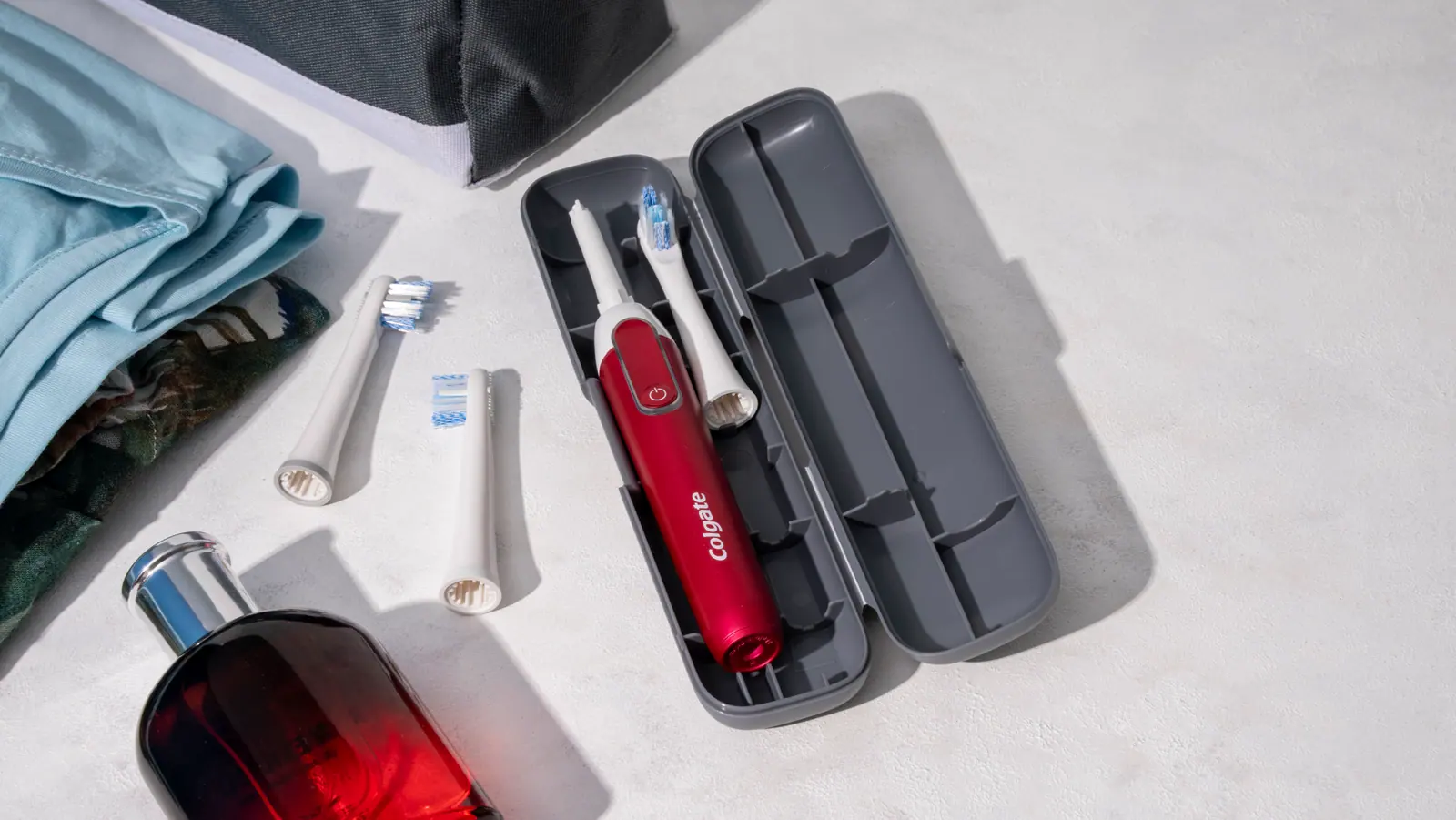Travel case with brush, spare heads and a red bottle
