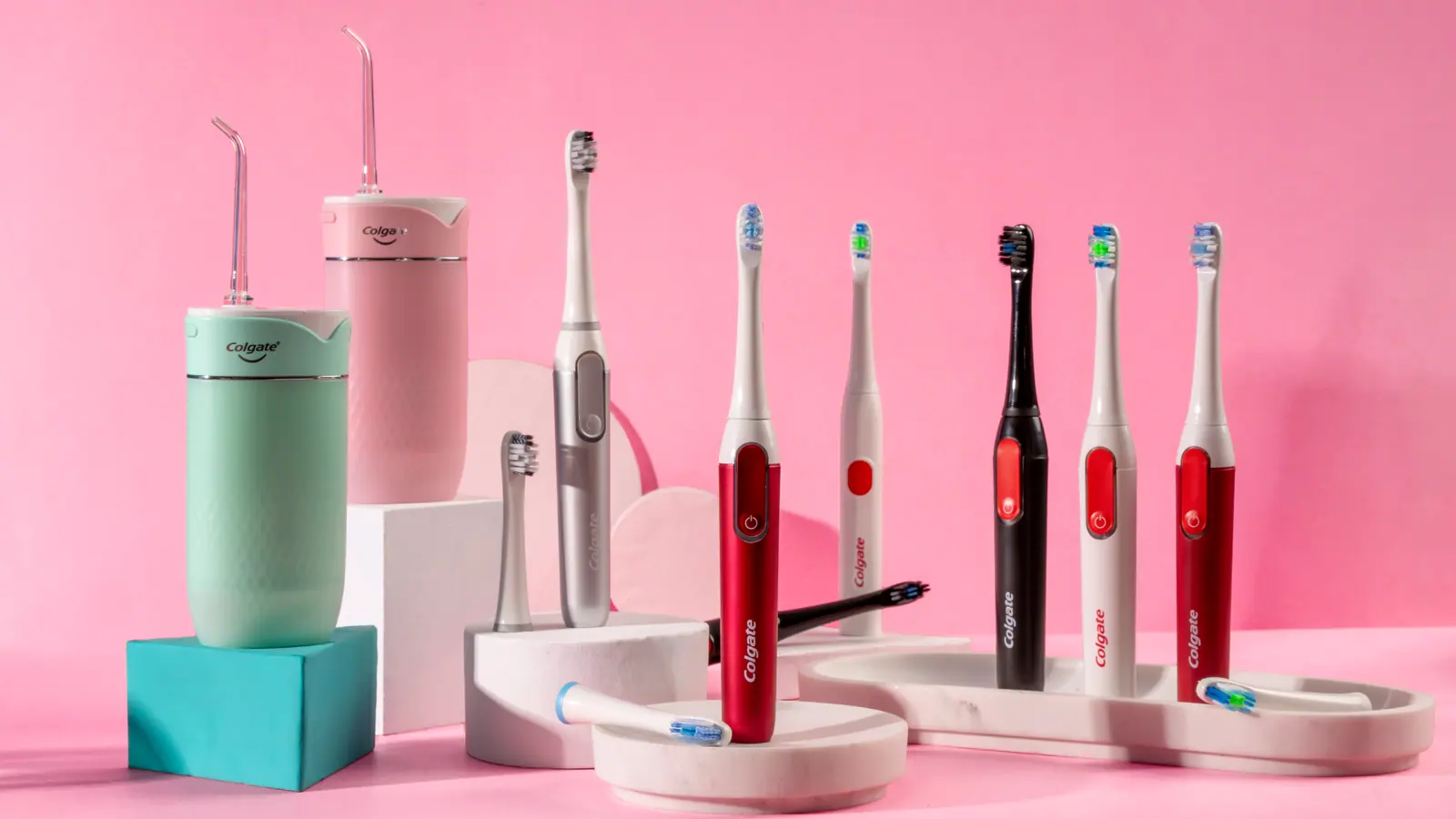 The full powered range on white plinths against a pink and teal set