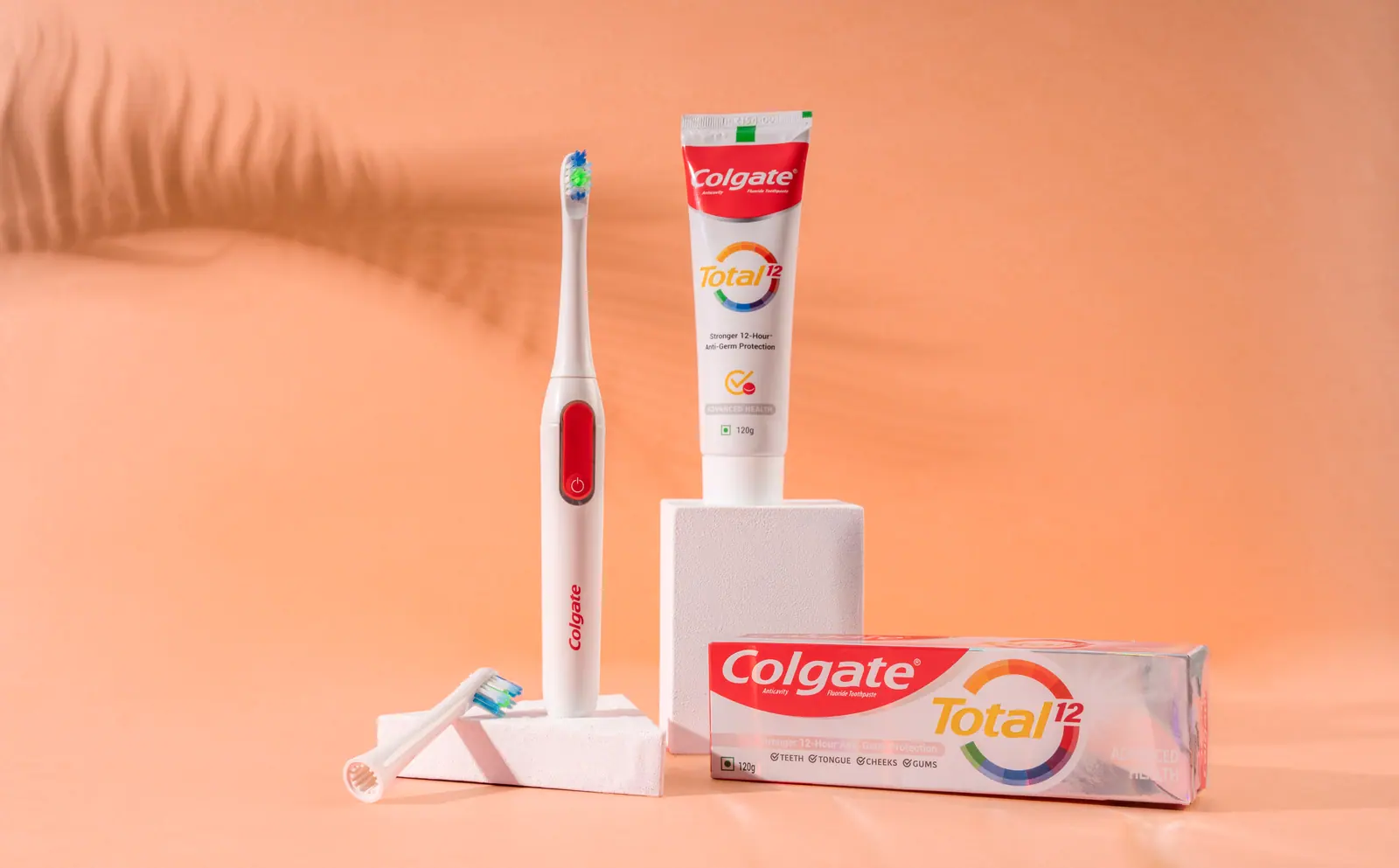 Brush and Colgate Total paste on peach